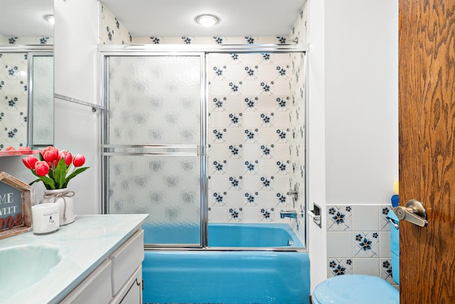 533 Lomond Dr, Mundelein, IL 60060 - bathroom with vanity, tile walls, combined bath / shower with glass door, and toilet