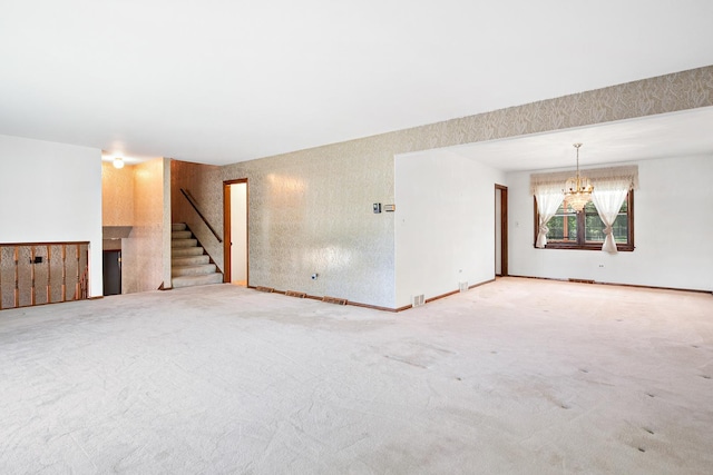 533 Lomond Dr, Mundelein, IL 60060 - unfurnished living room with stairs, carpet floors, and a chandelier