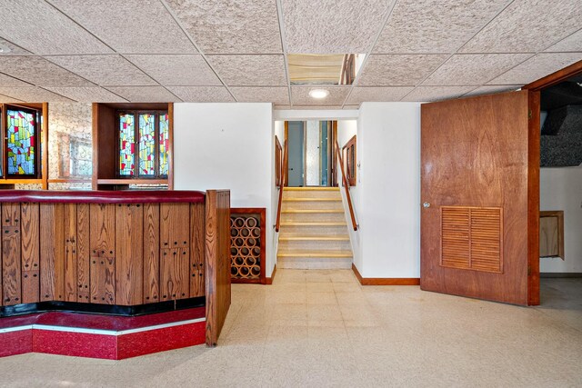 533 Lomond Dr, Mundelein, IL 60060 - indoor dry bar featuring tile patterned floors, baseboards, stairs, and a paneled ceiling