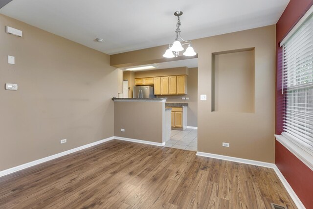 453 Lancaster Dr, Pingree Grove, IL 60140 - kitchen featuring freestanding refrigerator, wood finished floors, light brown cabinetry, and baseboards