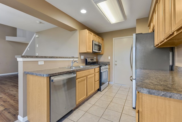 453 Lancaster Dr, Pingree Grove, IL 60140 - kitchen featuring appliances with stainless steel finishes, baseboards, light brown cabinetry, and a sink