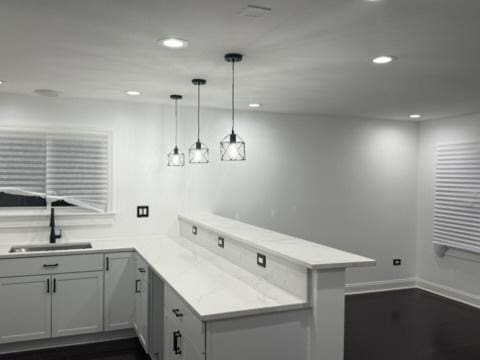 6903 S Ada St, Chicago, IL 60636 - kitchen featuring a peninsula, a sink, recessed lighting, baseboards, and hanging light fixtures