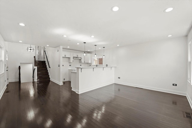 6903 S Ada St, Chicago, IL 60636 - unfurnished living room featuring baseboards, stairs, recessed lighting, and dark wood-type flooring