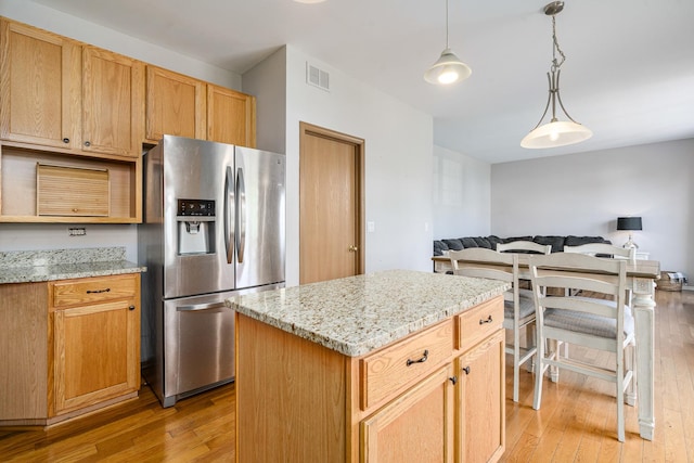 1453 Waterside Dr, Bolingbrook, IL 60490 - kitchen with stainless steel fridge with ice dispenser, light wood-type flooring, open floor plan, decorative light fixtures, and light stone countertops