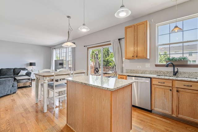 1453 Waterside Dr, Bolingbrook, IL 60490 - kitchen featuring dishwasher, light wood-style floors, open floor plan, a kitchen island, and light stone countertops