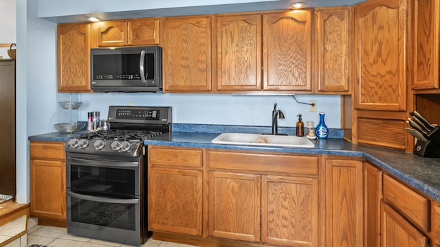 714 Cedardale Pl, Aurora, IL 60506 - kitchen with range with two ovens, dark countertops, light tile patterned floors, and brown cabinetry