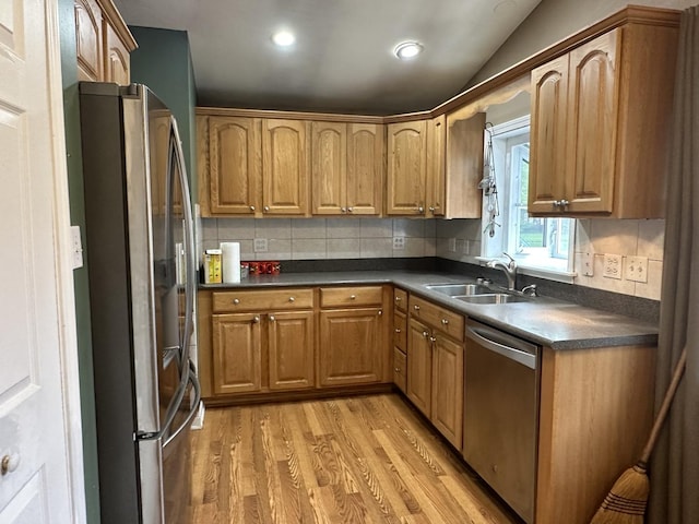 11024 Mason Ave, Chicago Ridge, IL 60415 - kitchen featuring appliances with stainless steel finishes, a sink, light wood-style flooring, dark countertops, and tasteful backsplash