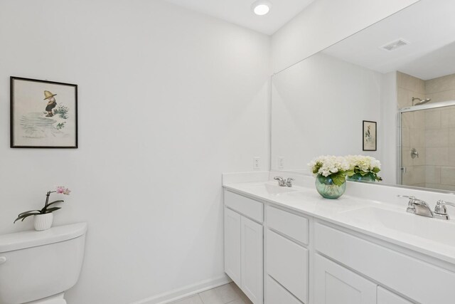 2011 Sequoia Ave, Mundelein, IL 60060 - bathroom featuring double vanity, toilet, a tile shower, and tile patterned floors