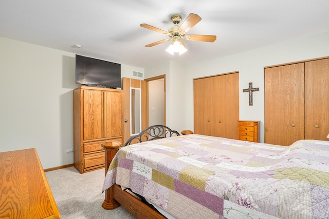 291 Georgetown Ave, Romeoville, IL 60446 - bedroom featuring multiple closets, light colored carpet, baseboards, and ceiling fan