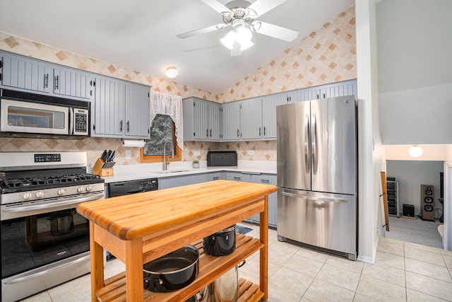 291 Georgetown Ave, Romeoville, IL 60446 - kitchen with appliances with stainless steel finishes, wallpapered walls, a sink, light countertops, and vaulted ceiling
