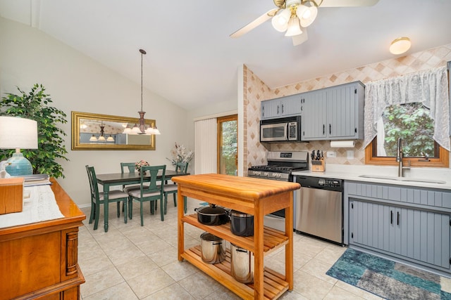 291 Georgetown Ave, Romeoville, IL 60446 - kitchen with stainless steel appliances, a sink, vaulted ceiling, a ceiling fan, and light tile patterned floors