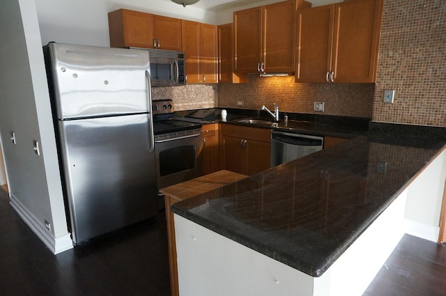 474 N Lake Shore Dr Unit 2101, Chicago, IL 60611 - kitchen with appliances with stainless steel finishes, a peninsula, a sink, dark wood finished floors, and backsplash