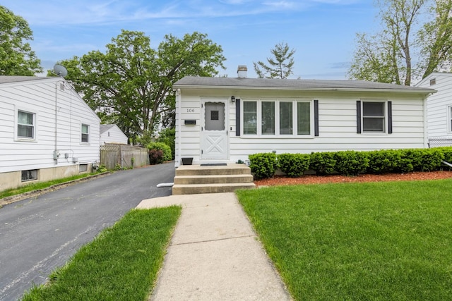 106 N Berteau Ave, Bartlett, IL 60103 - view of front of house featuring a chimney and a front lawn