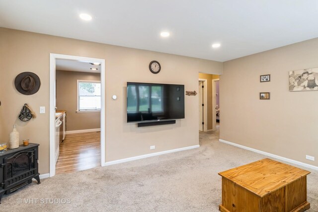 106 N Berteau Ave, Bartlett, IL 60103 - living room featuring a wood stove, carpet, baseboards, and recessed lighting