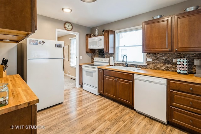 106 N Berteau Ave, Bartlett, IL 60103 - kitchen with butcher block countertops, white appliances, a sink, light wood-style flooring, and recessed lighting