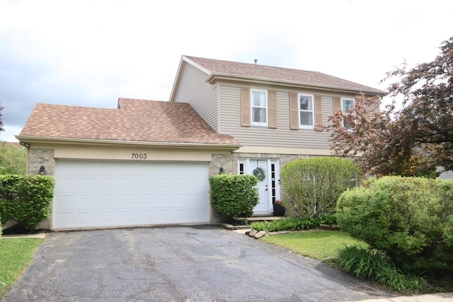 7003 94th Ave, Kenosha, WI 53142 - colonial inspired home featuring asphalt driveway, a garage, and a shingled roof