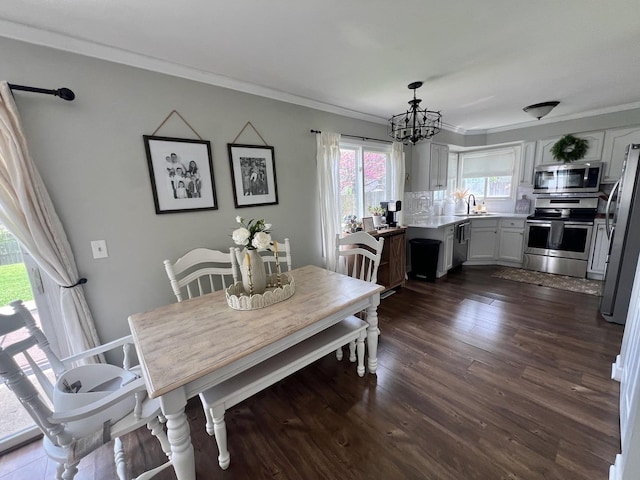 7003 94th Ave, Kenosha, WI 53142 - dining space with crown molding, a chandelier, and dark wood-style flooring