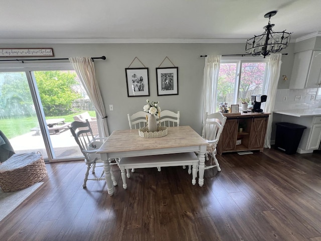7003 94th Ave, Kenosha, WI 53142 - dining space featuring a chandelier, ornamental molding, and dark wood-style flooring