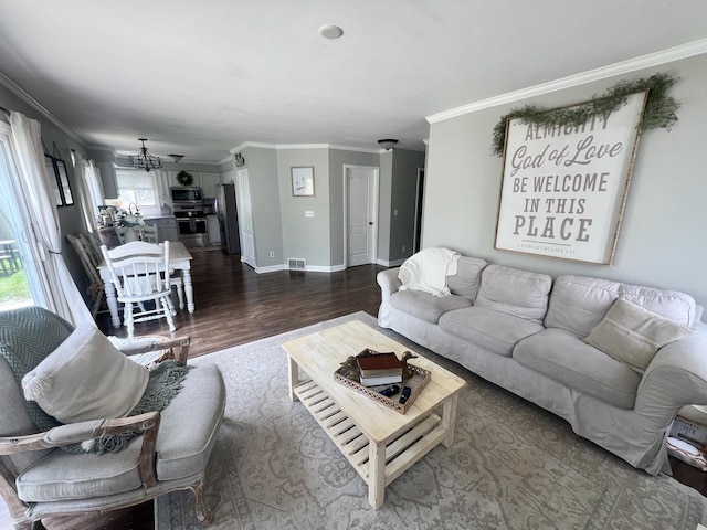 7003 94th Ave, Kenosha, WI 53142 - living room featuring wood finished floors, a chandelier, ornamental molding, and baseboards