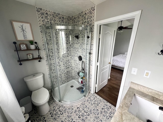 7003 94th Ave, Kenosha, WI 53142 - ensuite bathroom featuring toilet, a stall shower, a ceiling fan, and a sink
