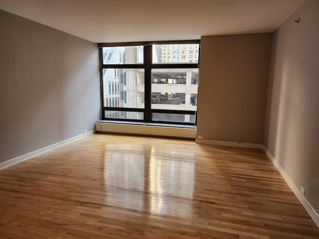 680 N Lake Shore Dr Unit 716, Chicago, IL 60611 - unfurnished room featuring wood finished floors, baseboards, and a baseboard heating unit