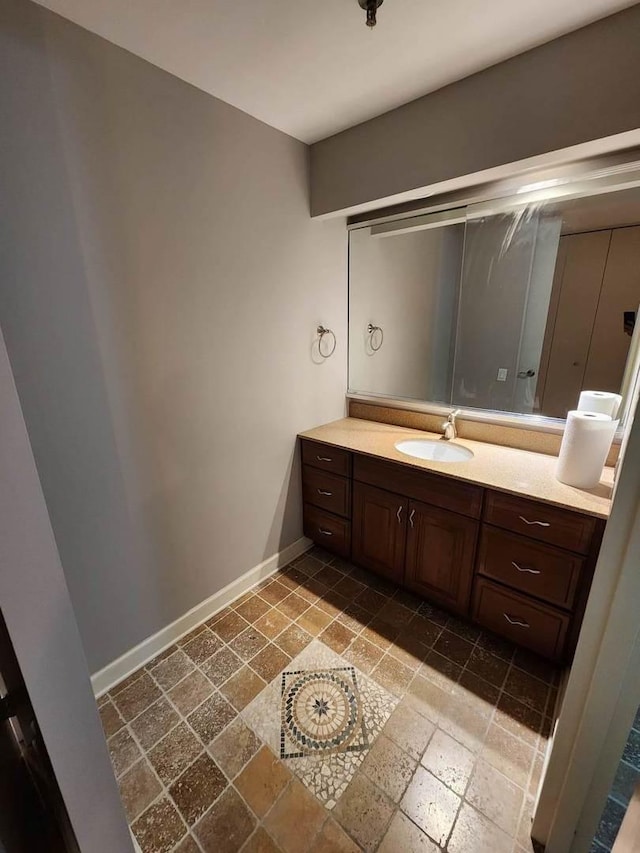 680 N Lake Shore Dr Unit 716, Chicago, IL 60611 - bathroom with vanity, baseboards, and stone tile floors