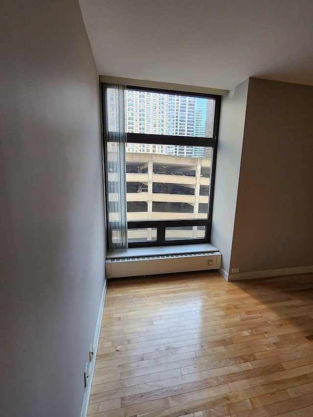 680 N Lake Shore Dr Unit 716, Chicago, IL 60611 - empty room featuring hardwood / wood-style floors, baseboards, and a wall of windows