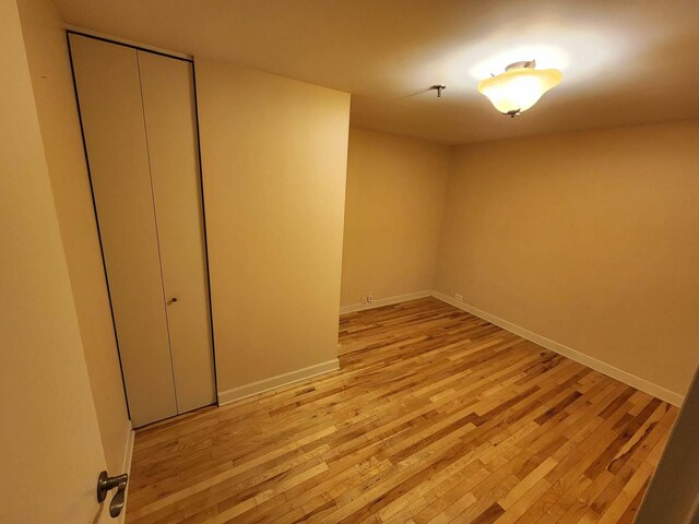 680 N Lake Shore Dr Unit 716, Chicago, IL 60611 - unfurnished bedroom featuring light wood-style floors, baseboards, and a closet
