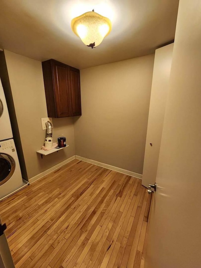 680 N Lake Shore Dr Unit 716, Chicago, IL 60611 - washroom featuring estacked washer and dryer, light wood-type flooring, and baseboards