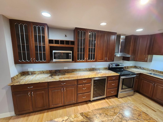 680 N Lake Shore Dr Unit 716, Chicago, IL 60611 - kitchen with appliances with stainless steel finishes, wine cooler, wall chimney exhaust hood, light wood-type flooring, and glass insert cabinets