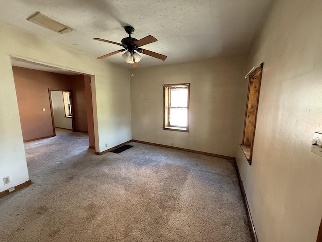 428 Chicago Ave, Savanna, IL 61074 - carpeted empty room featuring a ceiling fan, a textured ceiling, and baseboards