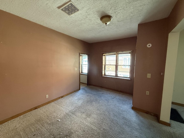 428 Chicago Ave, Savanna, IL 61074 - carpeted spare room featuring a textured ceiling and baseboards