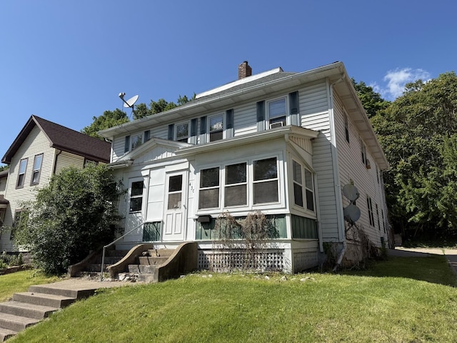428 Chicago Ave, Savanna, IL 61074 - view of front of property featuring a chimney and a front yard