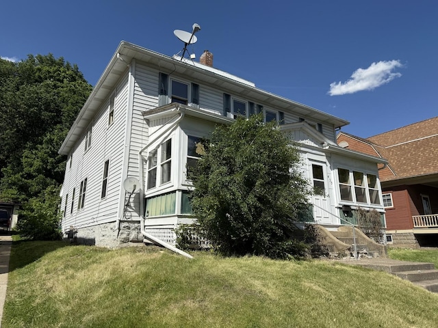 428 Chicago Ave, Savanna, IL 61074 - view of home's exterior with a chimney and a lawn