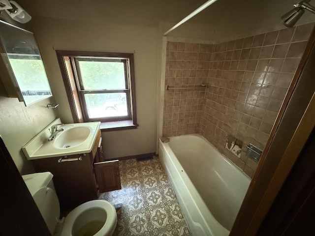428 Chicago Ave, Savanna, IL 61074 - full bathroom featuring vanity, toilet, washtub / shower combination, and baseboards