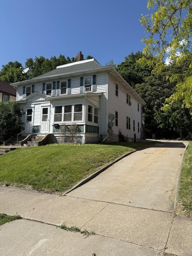 428 Chicago Ave, Savanna, IL 61074 - view of front of property featuring a chimney, a front yard, and driveway