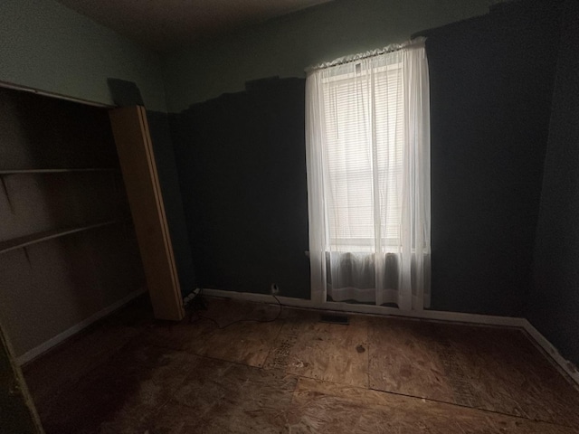 241 156th St, Calumet City, IL 60409 - unfurnished bedroom featuring multiple windows and baseboards