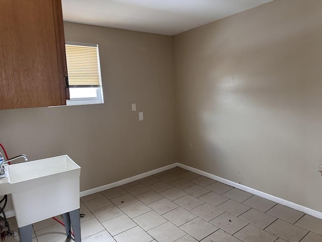 241 156th St, Calumet City, IL 60409 - unfurnished room featuring baseboards, a sink, and light tile patterned floors