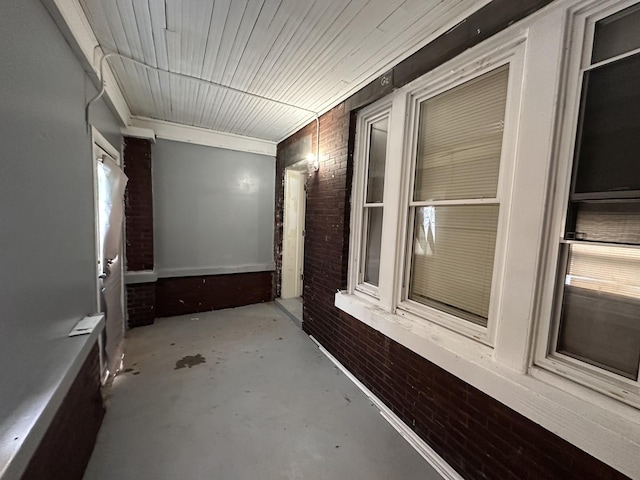 241 156th St, Calumet City, IL 60409 - corridor with brick wall and concrete flooring