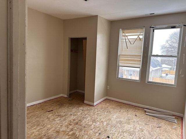 241 156th St, Calumet City, IL 60409 - unfurnished bedroom featuring multiple windows, baseboards, and a closet
