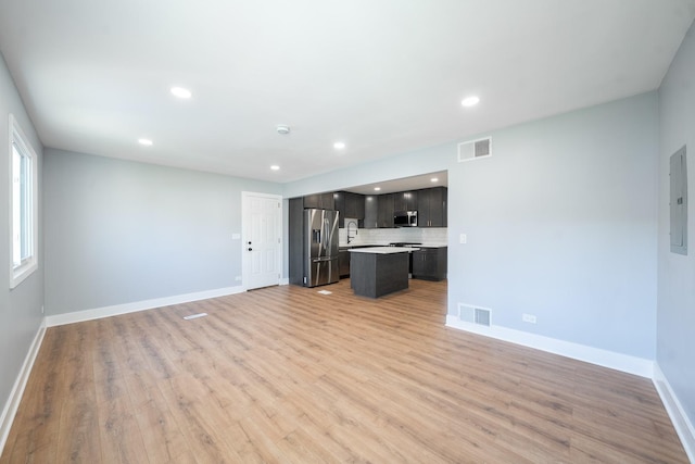 5831 Allemong Dr, Matteson, IL 60443 - unfurnished living room featuring light wood-style flooring, baseboards, recessed lighting, and electric panel