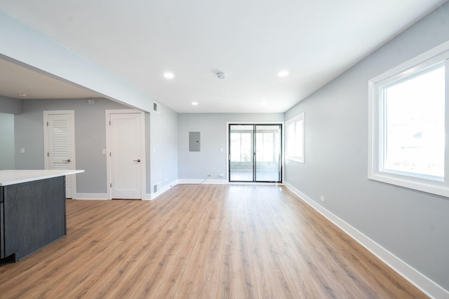 5831 Allemong Dr, Matteson, IL 60443 - unfurnished living room featuring light wood-style floors, baseboards, electric panel, and recessed lighting