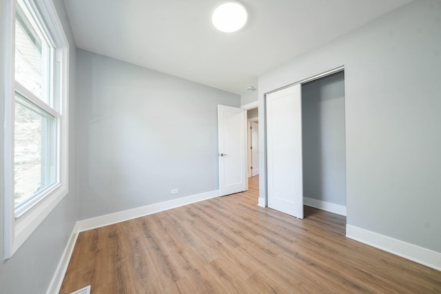 5831 Allemong Dr, Matteson, IL 60443 - unfurnished bedroom with wood finished floors, baseboards, and a closet