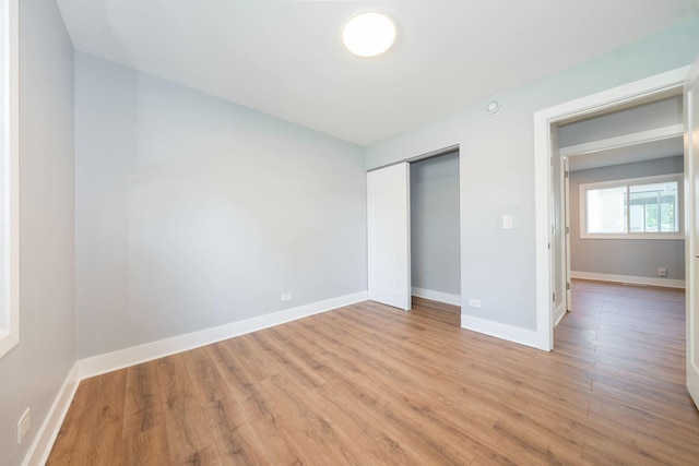 5831 Allemong Dr, Matteson, IL 60443 - unfurnished bedroom featuring light wood finished floors, a closet, and baseboards