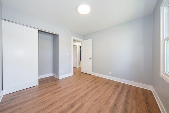 5831 Allemong Dr, Matteson, IL 60443 - unfurnished bedroom featuring light wood finished floors, baseboards, and a closet