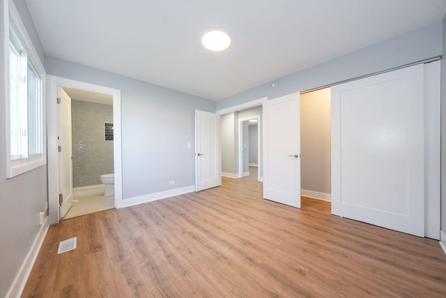 5831 Allemong Dr, Matteson, IL 60443 - unfurnished bedroom with light wood-style floors, baseboards, and a closet