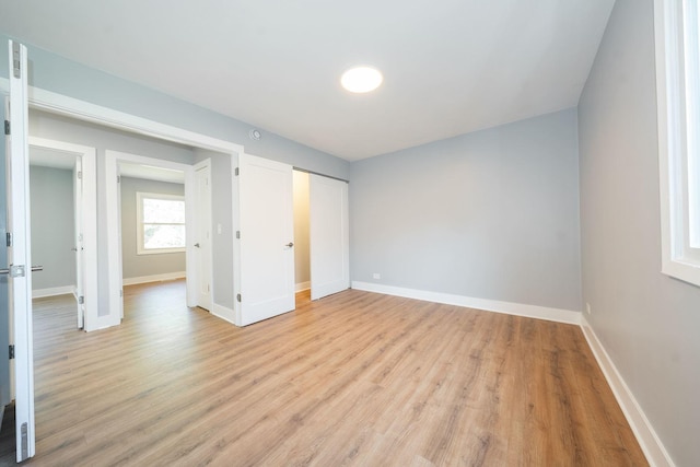 5831 Allemong Dr, Matteson, IL 60443 - unfurnished bedroom featuring baseboards, light wood-style floors, and a closet