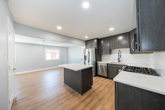 5831 Allemong Dr, Matteson, IL 60443 - kitchen featuring stainless steel appliances, a sink, backsplash, a center island, and light countertops