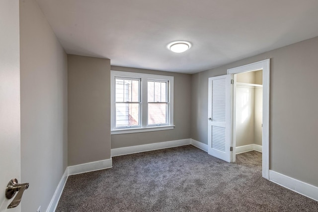 14746 Princeton Ave, Dolton, IL 60419 - unfurnished bedroom featuring dark colored carpet and baseboards