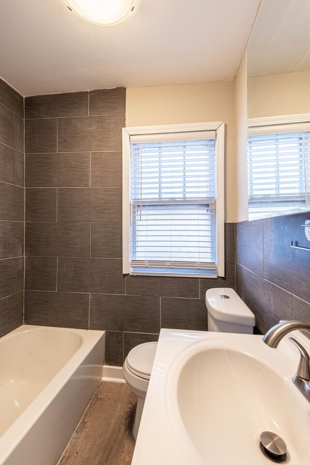 14746 Princeton Ave, Dolton, IL 60419 - bathroom featuring a sink, toilet, tile walls, and wood finished floors
